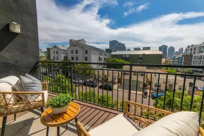 a balcony with furniture and a view of a city at The Italian Retreat, Little Italy in San Diego