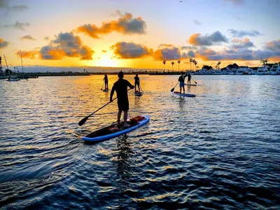 a group of people on paddle boards in the water at Convention close by 2BR Suite Free Parking in San Diego