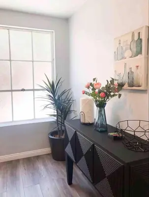 a room with a table with flowers and a window at Downtown SD 2BR Suite Free Parking Conv Center in San Diego