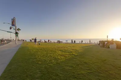 a person walking on a beach with the ocean in the background at Oceanfront 2BR Condo, Private Beach & Patio, Rare Find in Carlsbad