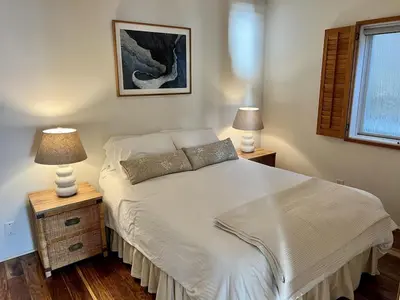 a bedroom with a white bed with two lamps at Oceanfront 2BR Condo, Private Beach & Patio, Rare Find in Carlsbad