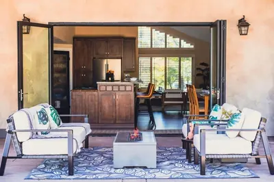 a living room with two chairs and a kitchen at Resort style back yard heated pool and spa in Encinitas