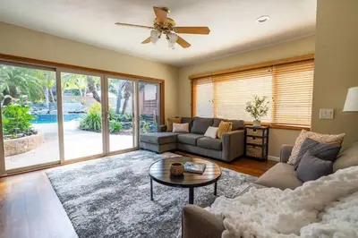a living room with a couch and a table at Resort style back yard heated pool and spa in Encinitas