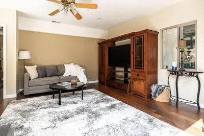 a living room with a couch and a tv at Resort style back yard heated pool and spa in Encinitas