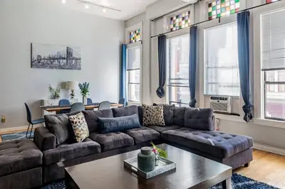 a living room with a couch and a table at Free Parking Walk to Conv Center 5 Beds Loft in San Diego