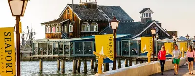 a building on a pier next to the water at Free Parking Walk to Conv Center 5 Beds Loft in San Diego