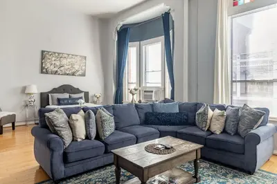 a blue couch in a living room with a table at Free Parking Loft Suite Walk to Conv Center in San Diego