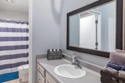 a bathroom with a sink and a mirror at Free Parking Loft Suite Walk to Conv Center in San Diego