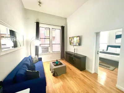 a living room with a blue couch and a table at 2BR Free Parking Walk to Convention Center in San Diego