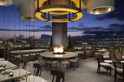 a restaurant with tables and chairs and a fire pit at Walk to Conv Center Free Parking 4 Beds in San Diego