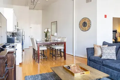 a living room with a couch and a table at Loft Suite Walk to Conv Center Free Parking in San Diego