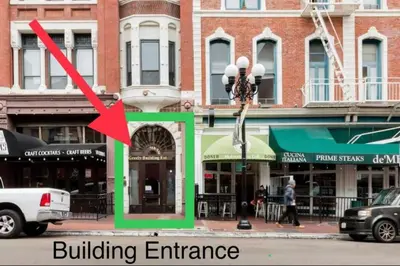 a building entrance on a city street with a red arrow at Loft Suite Walk to Conv Center Free Parking in San Diego