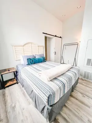 a bedroom with a large bed with blue pillows at 2BR Top Floor Suite Free Parking - Conv Center in San Diego