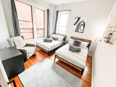 a living room with a couch and a chair at 2BR Top Floor Suite Free Parking - Conv Center in San Diego