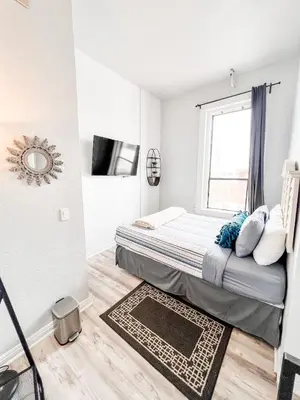 a small bedroom with a bed and a window at 2BR Top Floor Suite Free Parking - Conv Center in San Diego