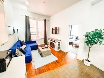 a living room with a blue couch and a fireplace at 2BR Top Floor Suite Free Parking - Conv Center in San Diego