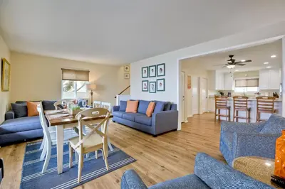 a living room with a blue couch and a table at Oceanfront 4BR, Private Beach & Patio, Remodeled Kitchen in Oceanside