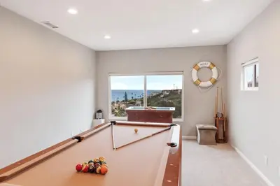 a billiard room with a pool table and a window at California Dreamin Your Ocean-View Sanctuary in San Diego