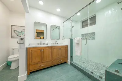 a bathroom with a shower and a sink and a toilet at 1185 Tamarack home in Carlsbad