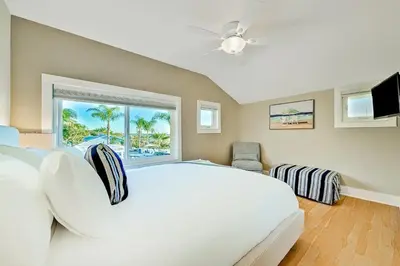 a bedroom with a large white bed and a window at 1185 Tamarack home in Carlsbad