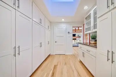 a kitchen with white cabinets and a skylight at 1185 Tamarack home in Carlsbad