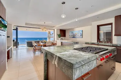 a kitchen with a counter top and a view of the ocean at Luxury Beachfront Home with Hot Tub & Ocean Views in San Diego