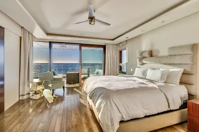a bedroom with a large bed and a large window at Luxury Beachfront Home with Hot Tub & Ocean Views in San Diego