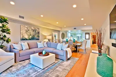 a living room with a couch and a table at Stunning Oceanfront Getaway at Windansea Beach in San Diego