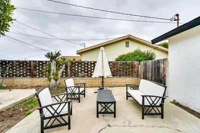 a patio with four chairs and an umbrella at Pet-Friendly San Diego Studio about 14 Mi to Downtown in San Diego