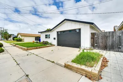 a white house with a black garage at Pet-Friendly San Diego Studio about 14 Mi to Downtown in San Diego