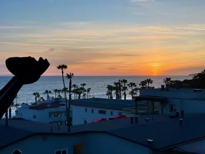 a view of the sunset from the roof of a building at SurfView VR - Best Ocean and Pier View, 5 mins to Beach, Cozy Patio, Pet Friendly in San Clemente