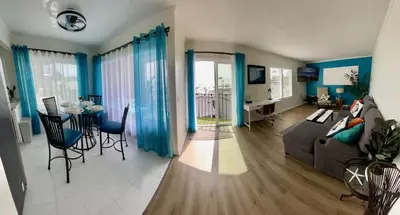 a living room with a couch and a table at SurfView VR - Best Ocean and Pier View, 5 mins to Beach, Cozy Patio, Pet Friendly in San Clemente