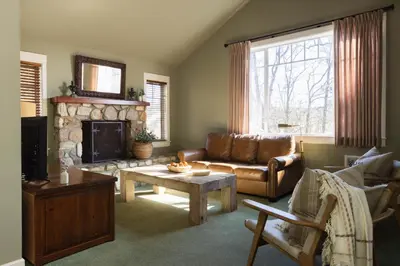 a living room with a couch and a fireplace at Orchard Hill in Julian