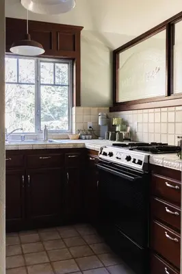 a kitchen with a black stove and a sink at Orchard Hill in Julian