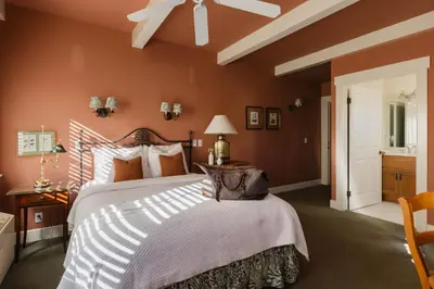 a bedroom with a large bed and a ceiling fan at Orchard Hill in Julian