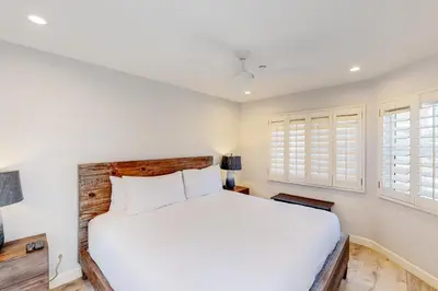 a bedroom with a white bed and windows at Pacific Sunset San Miguel 16 in Oceanside