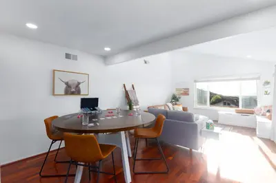 a living room with a table and chairs and a couch at Vacation Oasis! Ocean Views~Mini Golf~King-Suites in Solana Beach