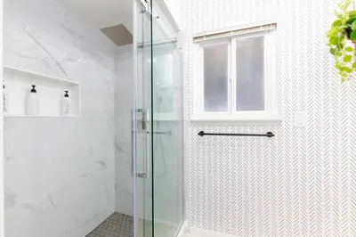 a shower with a glass door in a bathroom at Vacation Oasis! Ocean Views~Mini Golf~King-Suites in Solana Beach