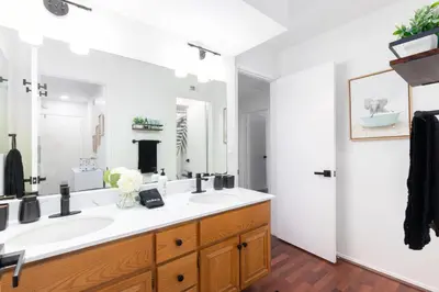 a bathroom with a sink and a large mirror at Vacation Oasis! Ocean Views~Mini Golf~King-Suites in Solana Beach