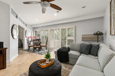 a living room with a couch and a ceiling fan at 683 Just inside the gates of the Resort - Golf & Premier Fitness Guests Welcome in Encinitas