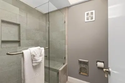 a bathroom with a shower with a glass door at 689 - Steps to the Resort, Peaceful Studio with free Wifi & Parking in Encinitas