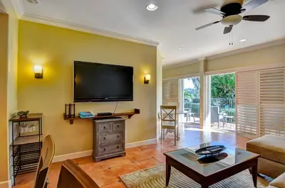 a living room with a flat screen tv on the wall at 604 Gorgeous Renovated Condo, Steps to Omni Spa, Golf, Tennis, PFC & Exclusive Building Pool in Encinitas