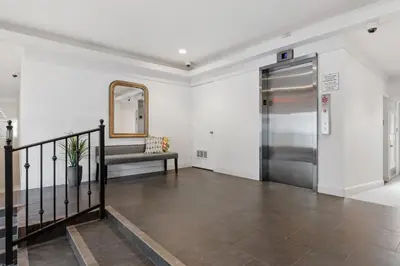 a hallway with a metal elevator and a mirror at 604 Gorgeous Renovated Condo, Steps to Omni Spa, Golf, Tennis, PFC & Exclusive Building Pool in Encinitas