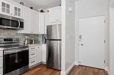 a kitchen with white cabinets and a stainless steel refrigerator at 628 Escape to Relaxation-Free Wifi-Free Parking in Encinitas