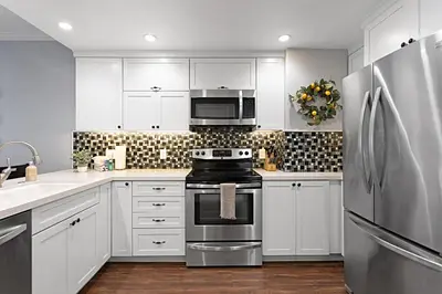 a kitchen with white cabinets and a stove top oven at 629 Walk to Restaurants Close to Golf and Spa Luxury Inside the gates in Encinitas