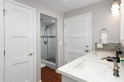 a white bathroom with a sink and a shower at 629 Walk to Restaurants Close to Golf and Spa Luxury Inside the gates in Encinitas