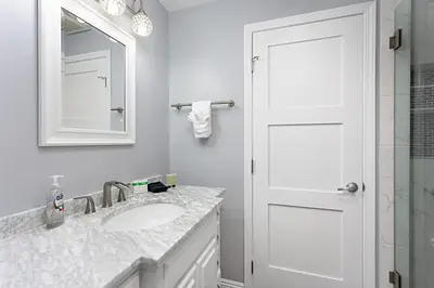 a white bathroom with a sink and a mirror at 629 Walk to Restaurants Close to Golf and Spa Luxury Inside the gates in Encinitas