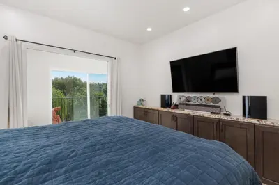 a bedroom with a bed and a flat screen tv at 644 A Renovated Condo at a World-Renowned Resort - Free Wifi and Parking in Encinitas