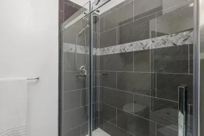 a shower with a glass door in a bathroom at 644 A Renovated Condo at a World-Renowned Resort - Free Wifi and Parking in Encinitas