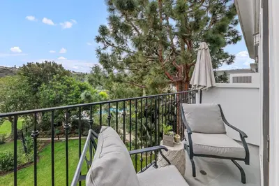 a balcony with a chair and an umbrella at 644 A Renovated Condo at a World-Renowned Resort - Free Wifi and Parking in Encinitas